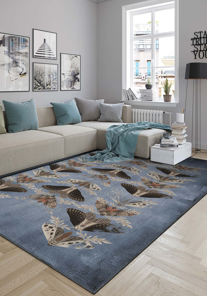 Living room with a blue butterfly-patterned rug on a wooden floor.