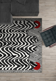 Black and white striped rug with red dots.